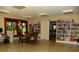 Living room with tile flooring, built-in bookshelves, and a large window providing plenty of natural light at 6042 Red Maple Rd # 1001, Bradenton, FL 34210