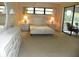 Bright main bedroom with a large bed frame, two side tables, and large windows at 6042 Red Maple Rd # 1001, Bradenton, FL 34210