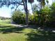 Picturesque walking path surrounded by lush greenery and mature trees, offering a serene escape at 6042 Red Maple Rd # 1001, Bradenton, FL 34210