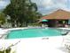 Sparkling community pool with lounge chairs and tables, perfect for relaxing in the sun at 6042 Red Maple Rd # 1001, Bradenton, FL 34210
