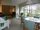 Inviting sunroom featuring comfortable seating, glass table, and views of the outdoors at 6042 Red Maple Rd # 1001, Bradenton, FL 34210