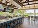 Modern bar area with seating, televisions, and scenic views of the water at 6316 Walton Heath Pl, University Park, FL 34201