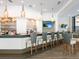 A stylish bar area featuring pendant lighting and seating for six at 6316 Walton Heath Pl, University Park, FL 34201