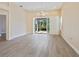 Bright bedroom with light-colored walls, light tile floor, ceiling fan, and sliding glass doors to the porch at 6316 Walton Heath Pl, University Park, FL 34201
