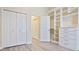Spacious closet featuring custom built-in storage and laminate floors at 6316 Walton Heath Pl, University Park, FL 34201