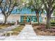 Clubhouse entrance with well-manicured landscaping, an inviting walkway, and bright blue-trimmed doors and windows at 6316 Walton Heath Pl, University Park, FL 34201