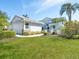 Charming home with a well-manicured lawn and beautiful landscaping, creating a welcoming curb appeal at 6316 Walton Heath Pl, University Park, FL 34201