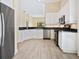 Bright kitchen with stainless steel appliances and white cabinetry, offering ample countertop space at 6316 Walton Heath Pl, University Park, FL 34201