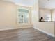 Living room with light-colored walls, plantation shutters, and wood-look tile floor at 6316 Walton Heath Pl, University Park, FL 34201