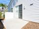 A simple patio area is accessed from a sliding glass door and is surrounded by a privacy wall at 6316 Walton Heath Pl, University Park, FL 34201