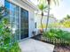 This patio offers a lovely outdoor space with tropical landscaping and a decorative white picket fence at 6316 Walton Heath Pl, University Park, FL 34201