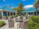 Inviting patio with comfortable seating, lush landscaping, and umbrellas, perfect for relaxing outdoors at 6316 Walton Heath Pl, University Park, FL 34201