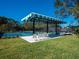 Outdoor recreation area with pickleball courts, shade structure, and seating at 6316 Walton Heath Pl, University Park, FL 34201