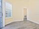 Neutral room with door to another space and large windows, showcasing plank flooring at 6316 Walton Heath Pl, University Park, FL 34201