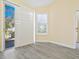Neutral room with a door to outdoors and another door to an interior space, showcasing plank flooring at 6316 Walton Heath Pl, University Park, FL 34201
