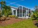 A screened porch provides a relaxing outdoor space with views of the lush landscaping at 6316 Walton Heath Pl, University Park, FL 34201