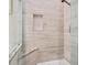 A tiled shower with a built-in seat and shower niche at 6316 Walton Heath Pl, University Park, FL 34201