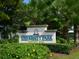 Signage for the University Park Country Club shows the beautiful landscaping in the area at 6316 Walton Heath Pl, University Park, FL 34201