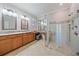 Bathroom featuring dual sinks, a vanity area, and a glass-enclosed shower at 6857 Wild Lake Ter, Bradenton, FL 34212