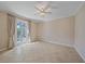 Bright bedroom featuring tile floors, ceiling fan, and private access to the pool area at 6857 Wild Lake Ter, Bradenton, FL 34212