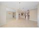 Spacious open-concept living area with tile flooring and elegant chandelier at 6857 Wild Lake Ter, Bradenton, FL 34212