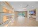 Bright living room features custom shelving, a tv and sliding glass doors to the patio at 6857 Wild Lake Ter, Bradenton, FL 34212