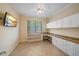 Office space featuring a built-in desk, storage cabinets, and a large window for natural light at 6857 Wild Lake Ter, Bradenton, FL 34212
