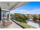 This beautiful covered outdoor balcony includes comfortable seating and scenic water views at 7003 Holmes Blvd, Holmes Beach, FL 34217