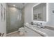Modern bathroom with walk-in shower, featuring a sleek vanity and decorative light fixture at 7003 Holmes Blvd, Holmes Beach, FL 34217