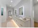 Modern bathroom featuring double vanity, under-cabinet lighting and decorative wall mirrors at 7003 Holmes Blvd, Holmes Beach, FL 34217