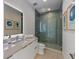Updated bathroom with shower, sleek vanity, and decorative art at 7003 Holmes Blvd, Holmes Beach, FL 34217