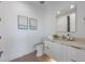 Modern bathroom with a sleek vanity, updated sink and fixtures, plus a toilet and neutral flooring at 7003 Holmes Blvd, Holmes Beach, FL 34217