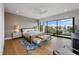 This main bedroom includes a large bed, ceiling fan, hardwood floors, and access to a covered balcony at 7003 Holmes Blvd, Holmes Beach, FL 34217