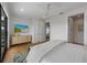 Bright bedroom featuring white walls, wood floors, a ceiling fan and modern decor throughout at 7003 Holmes Blvd, Holmes Beach, FL 34217