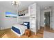 bedroom with bunkbeds, wood flooring, shelves and natural light at 7003 Holmes Blvd, Holmes Beach, FL 34217