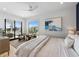 Bright bedroom with a ceiling fan, light neutral decor and balcony access for seamless indoor-outdoor living at 7003 Holmes Blvd, Holmes Beach, FL 34217