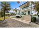 Beautiful modern two-story home with a well-maintained yard and lush landscaping at 7003 Holmes Blvd, Holmes Beach, FL 34217