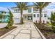 Beautiful modern home with manicured lawn, palm trees and two stories of luxury at 7003 Holmes Blvd, Holmes Beach, FL 34217