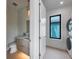 Cozy half bathroom with modern vanity, stylish mirror, a window view, and a washer/dryer set at 7003 Holmes Blvd, Holmes Beach, FL 34217