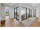 Bright hallway featuring hardwood floors and glass-enclosed sitting room with comfortable seating at 7003 Holmes Blvd, Holmes Beach, FL 34217