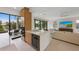 Modern kitchen featuring a large island, stainless steel appliances, and views of the outdoor patio at 7003 Holmes Blvd, Holmes Beach, FL 34217