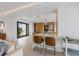 Stylish kitchen with bar seating seamlessly connecting the living space for a cohesive entertaining area at 7003 Holmes Blvd, Holmes Beach, FL 34217