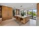 Modern kitchen featuring a spacious center island, barstools, and sleek cabinetry at 7003 Holmes Blvd, Holmes Beach, FL 34217