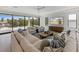 Spacious living room with large windows, comfortable seating, and modern decor with great outdoor views at 7003 Holmes Blvd, Holmes Beach, FL 34217