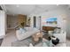 Inviting living room with a modern sofa, decorative rug, and view of the wooden slat wall and staircase at 7003 Holmes Blvd, Holmes Beach, FL 34217