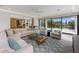 Open concept living area featuring stylish furniture, geometric rug and seamless transition to the outdoor space at 7003 Holmes Blvd, Holmes Beach, FL 34217