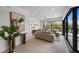 Elegant living room with sliding glass doors, stylish decor, and ample natural light creating an airy ambiance at 7003 Holmes Blvd, Holmes Beach, FL 34217