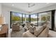 Bright living room with comfortable seating, access to outdoor space, and a serene ambiance for relaxation at 7003 Holmes Blvd, Holmes Beach, FL 34217