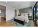 Relaxing main bedroom boasts hardwood floors, a bench, and access to the ensuite bathroom at 7003 Holmes Blvd, Holmes Beach, FL 34217