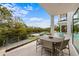 Outdoor dining and entertainment area with a pool and waterfront views at 7003 Holmes Blvd, Holmes Beach, FL 34217
